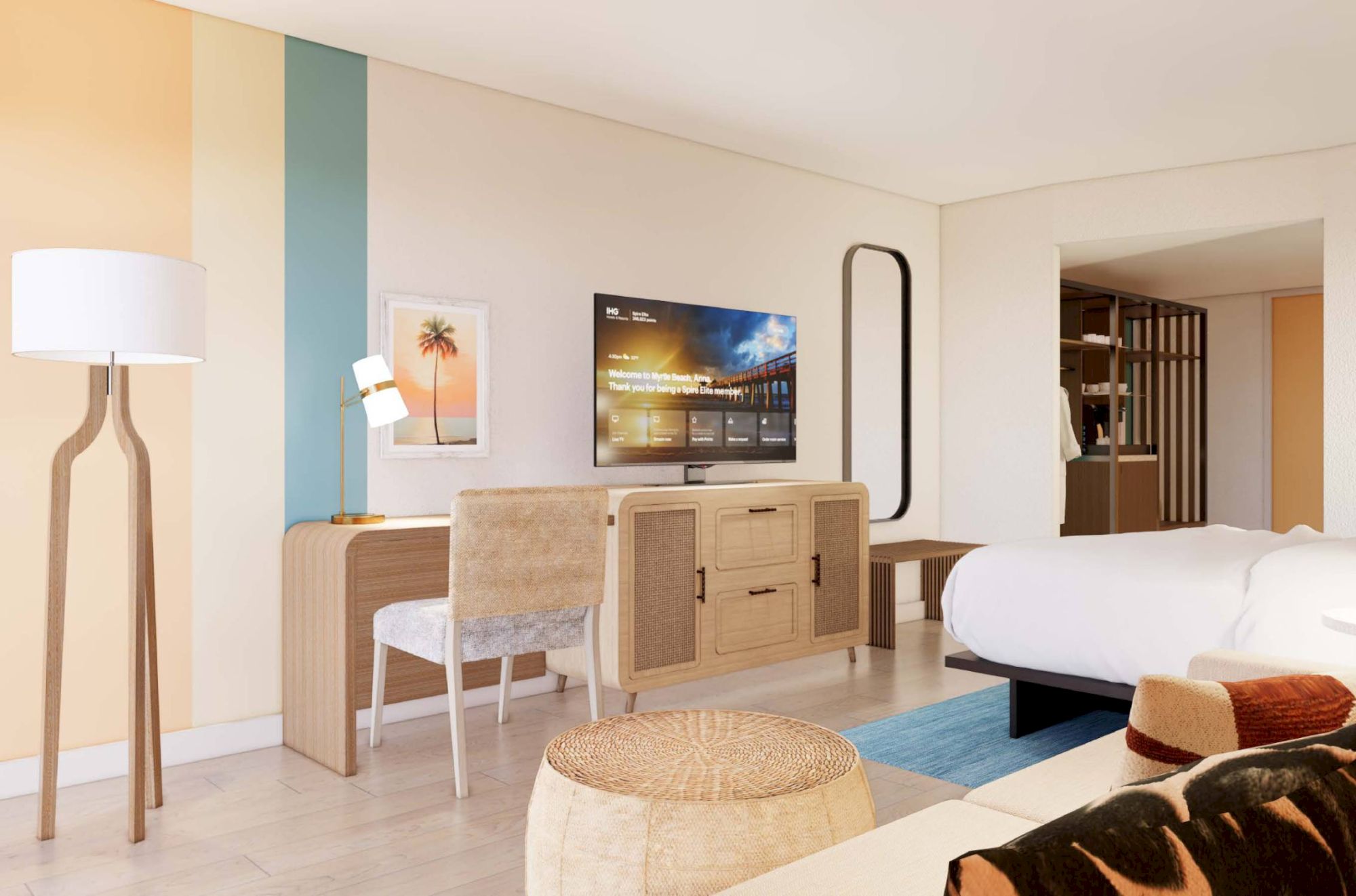 A modern hotel room with a bed, TV, desk, lamp, and cozy seating. The decor features warm tones and stylish furniture.