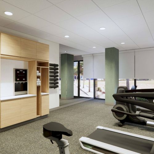 The image shows a gym room with exercise equipment, a wooden cabinet, and weights on the wall, featuring bright overhead lighting.