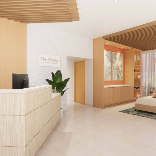 A modern waiting area with light wood decor, a reception desk, plants, and natural light streaming in through large windows.