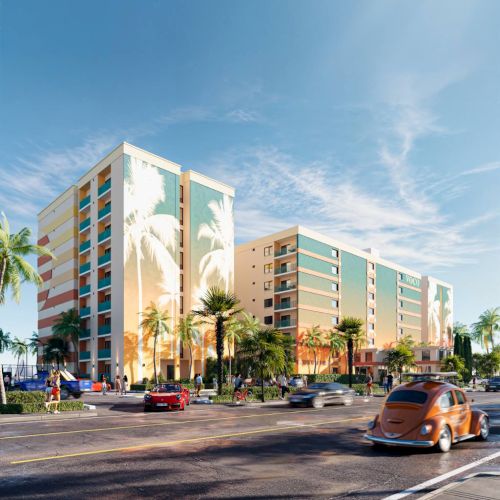 A vibrant street scene with cars, palm trees, and colorful buildings under a clear sky, giving a tropical urban vibe.