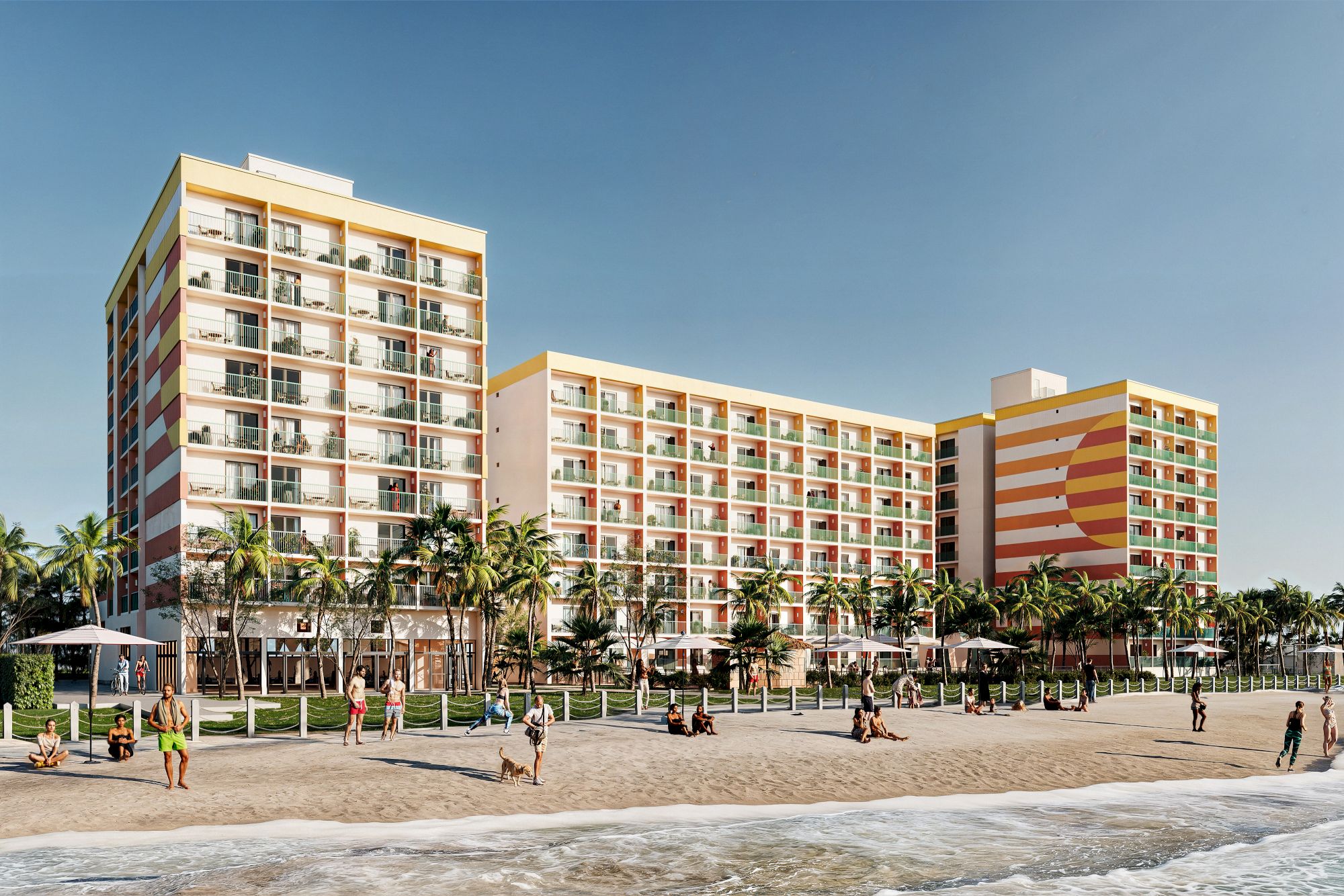 A beachside hotel with colorful balconies, surrounded by palm trees. People are enjoying the beach and walking along the shore.